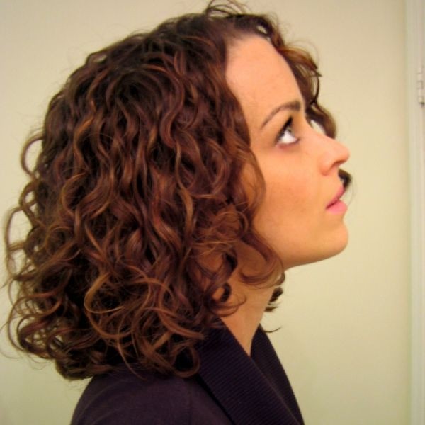 A girl in black top showing the side view of her tapered curls hairstyles - hair color mistakes