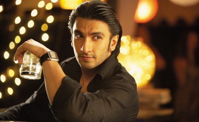 Ranveer Singh in black shirt holding a glass and showing his romantic look with half get hairstyles - Ranveer Singh latest hairstyles