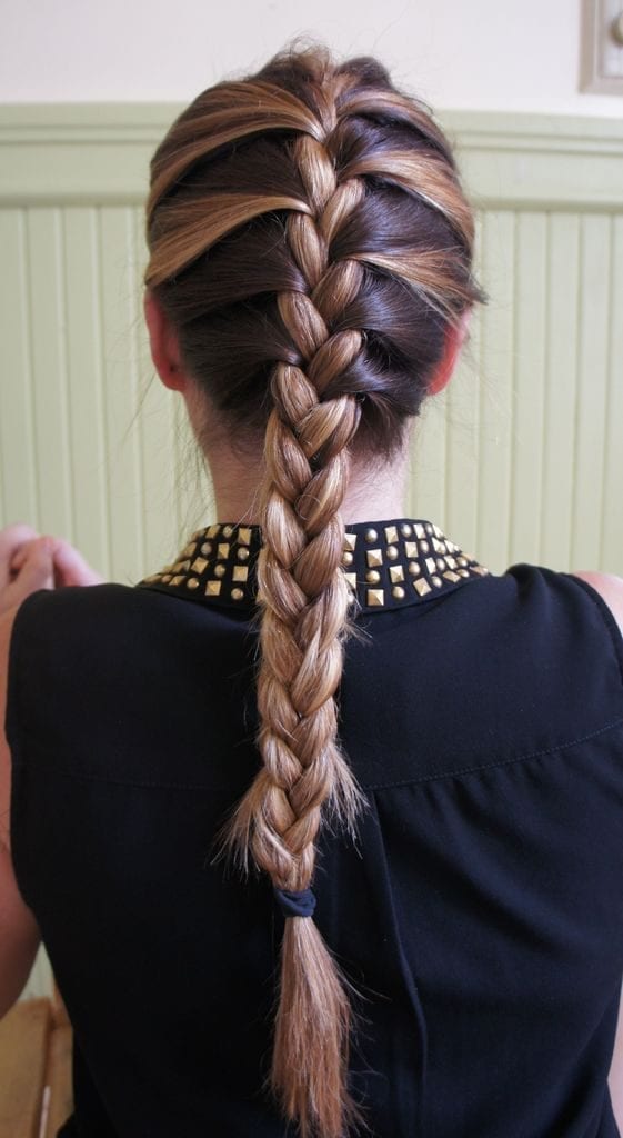A women in black shirt showing the back view of her Side French braid - Long hairstyles for American Women