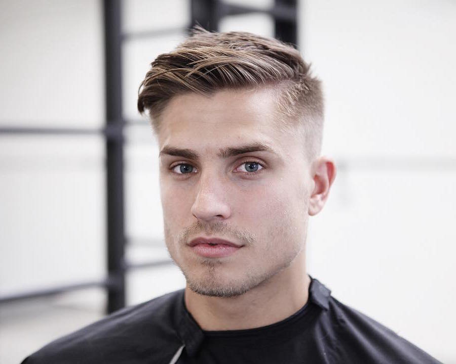 A  man in black t-shirt showing his Short Haircut with High Fade Hair style - Latest Hair Cut for Men and Boys