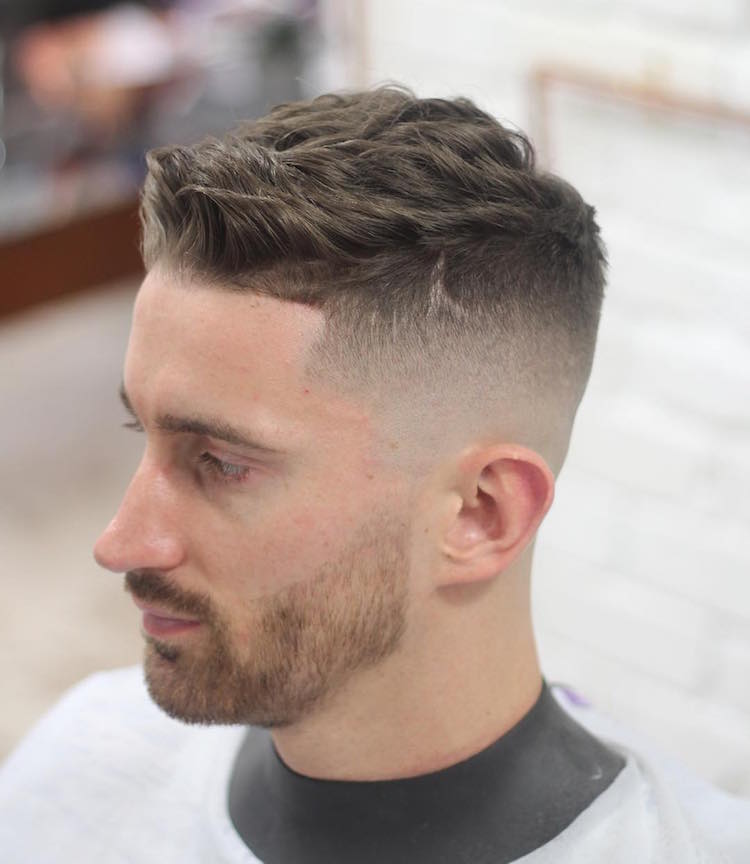 A man in grey t-shirt showing the side view of his Short Wavy Hair with High Fade Hair style - Latest Hair Cut for Men and Boys