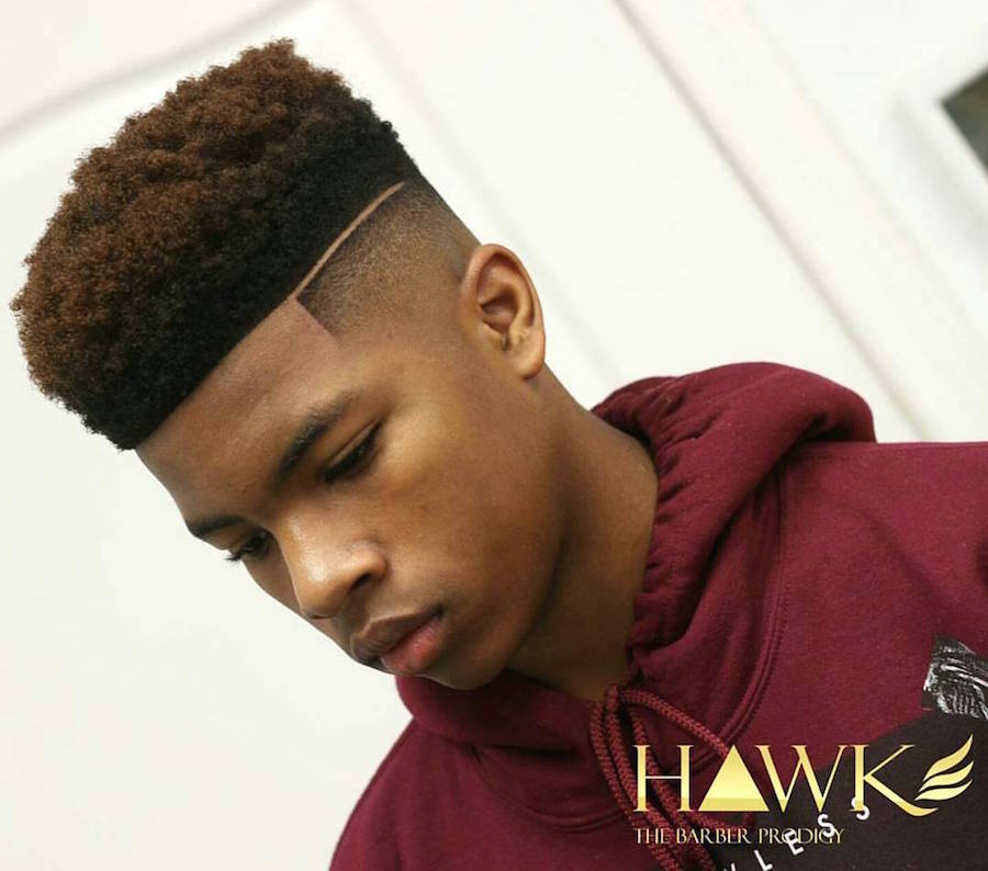 A man in maroon hoodie showing the side view of his Tall Natural Curves with High Fade - trendy haircuts for boys