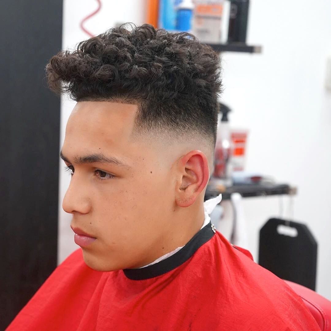 A boy showing the side view of his Bald Fade with Curly Hair - haircuts for men with curly hair