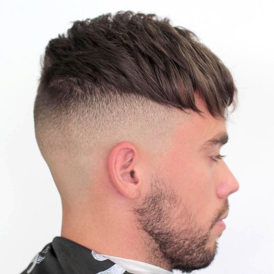 A man in grey high neck t-shirt showing the side view of his Short Crop Undercut - Latest Hair Cut for Men and Boys