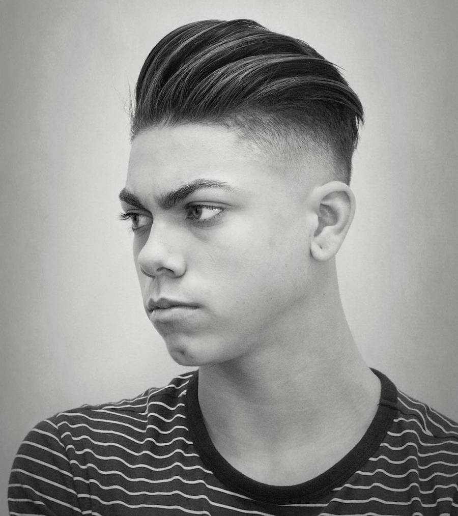 A boy in lining round neck t-shirt showing the side view of his Slicked back Undercut - haircut for male