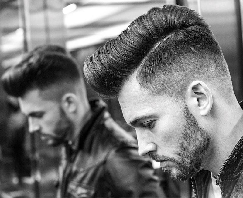 A man in black leather jacket showing the side view of her High Fade Combover - haircuts for men