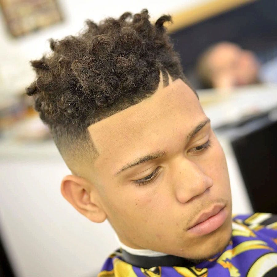 A boy showing the side view of his Double Hard Part with Natural Curls - Latest Hair Cut for Men and Boys