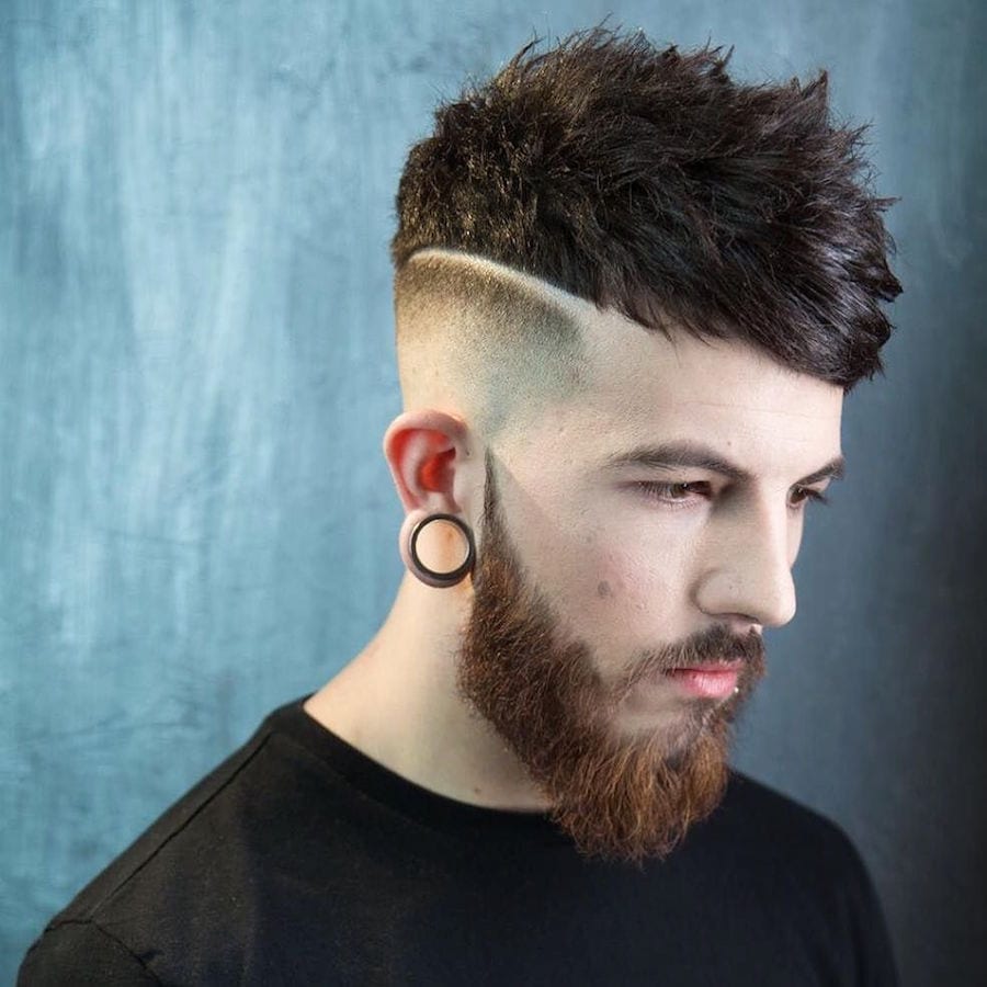 a man in black round neck t-shirt and round earring showing the side view of her Short Hair with Hard Part - Latest Hair Cut for Men and Boys