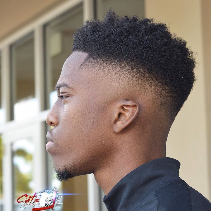 A boy in blue high neck jacket showing the side view of his High bald Fade - Latest Hair Cut for Men and Boys