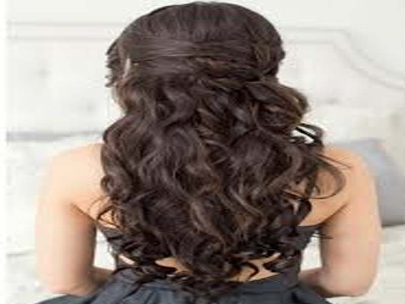 A girl in black dress showing the back view of her curly hairstyle - hairstyles for girls