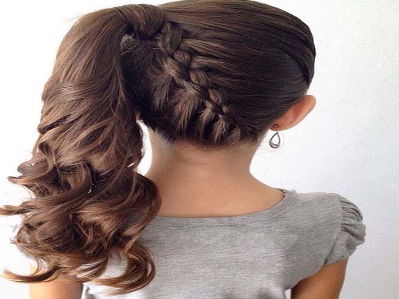 A girl in grey top showing the back view of her hairstyle - hairstyles for girls with curly hair
