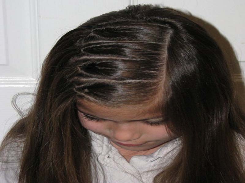A girl in white shirt showing her multi lining hairstyle -  latest hairstyles for girls