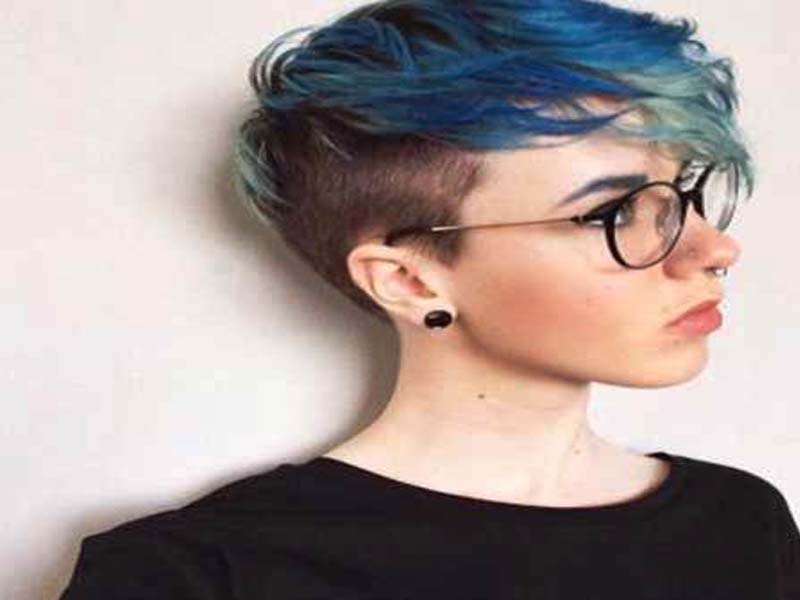 A girl in black top with spectacles showing her colored pixie hairstyle -  latest hairstyles for girls