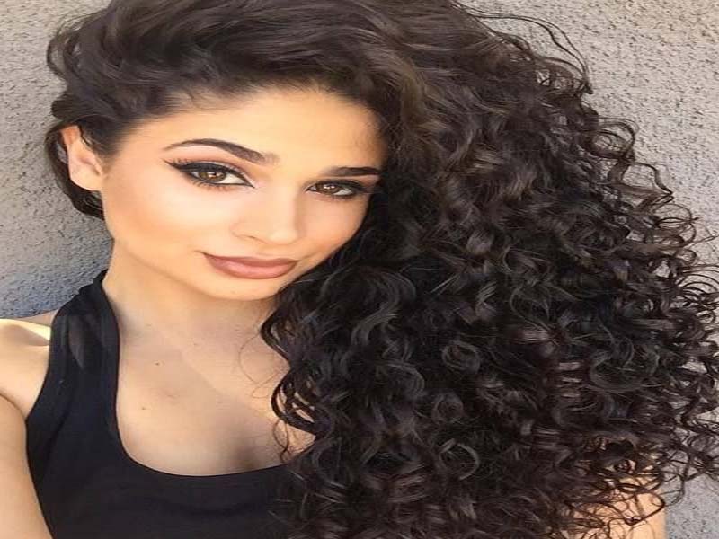 A girl in black tank top showing her curls - hairstyles for girls with long hair