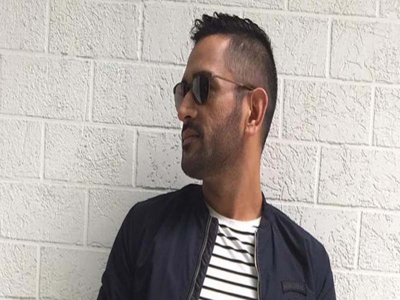 Dhoni in blue jacket with ling t-shirt and goggles - MS Dhoni short hairstyle