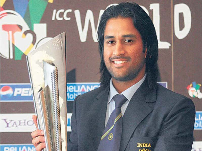 MS Dhoni in blue suit holding t-20 world cup trophy - latest hairstyles of MS Dhoni