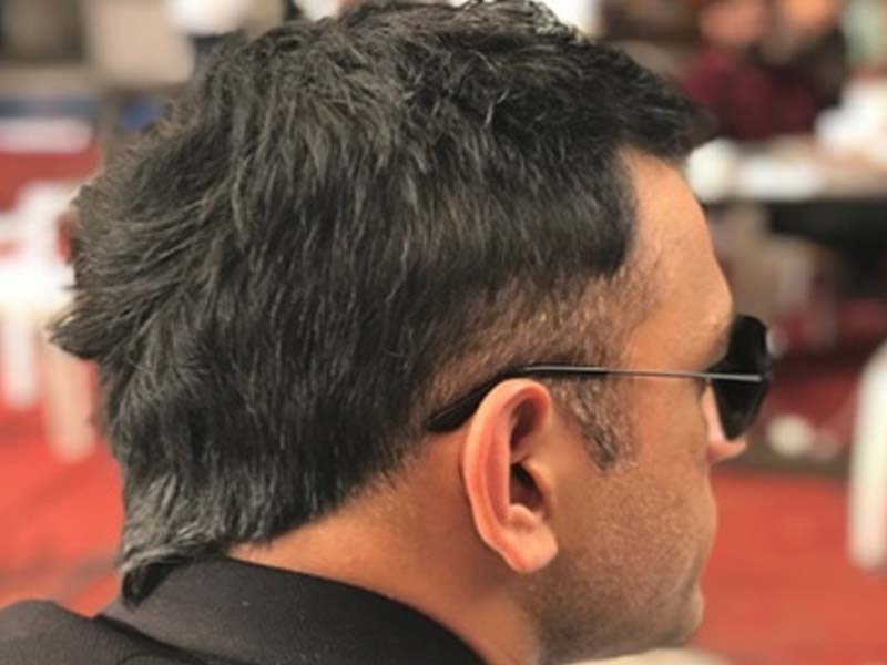 MS Dhoni in goggles showing the back view of his spikes haircut - MS Dhoni haircut 