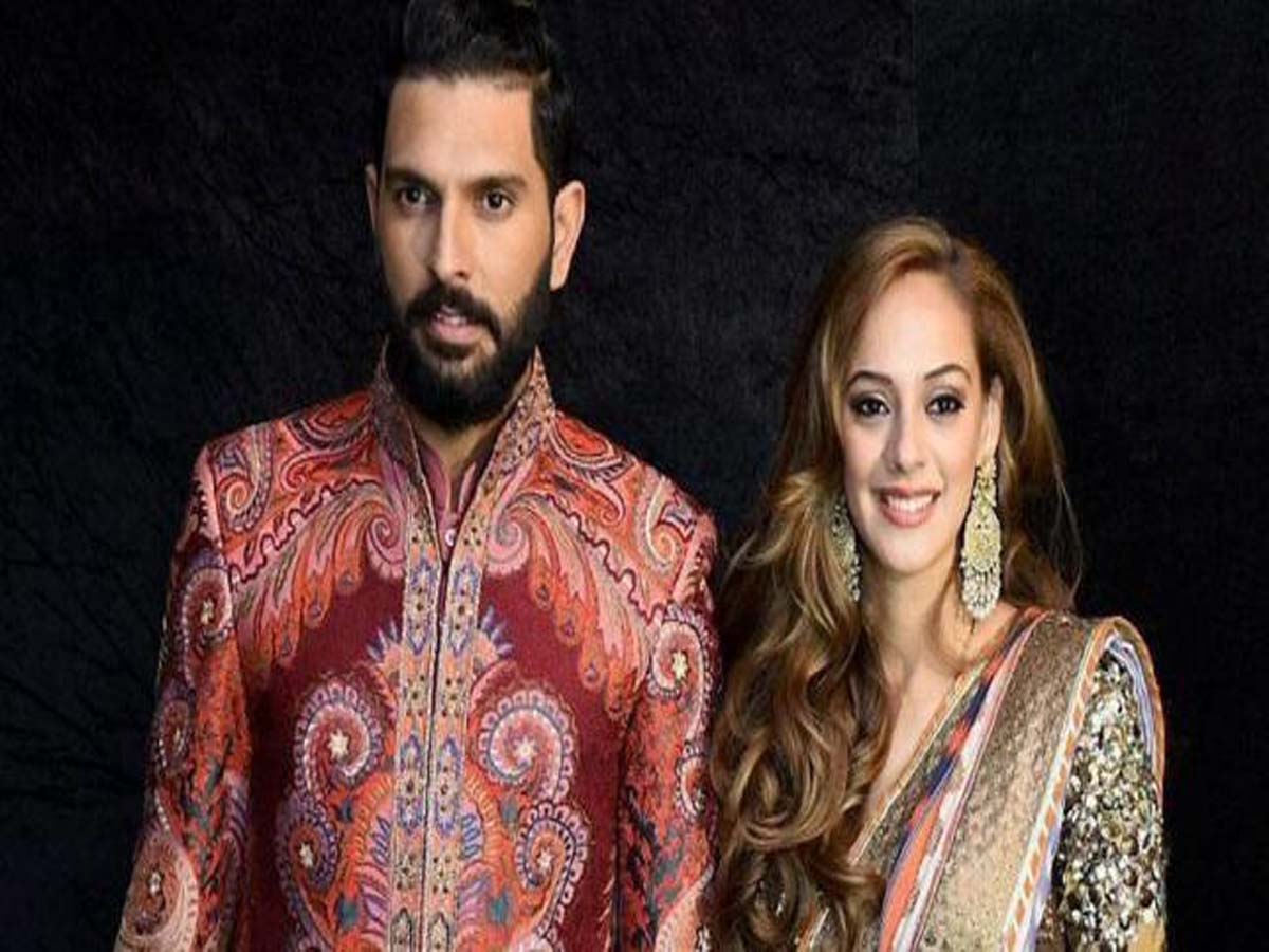 Yuvraj Singh and Hazel Keech in traditional outfit posing for camera - indian cricketers and their wives