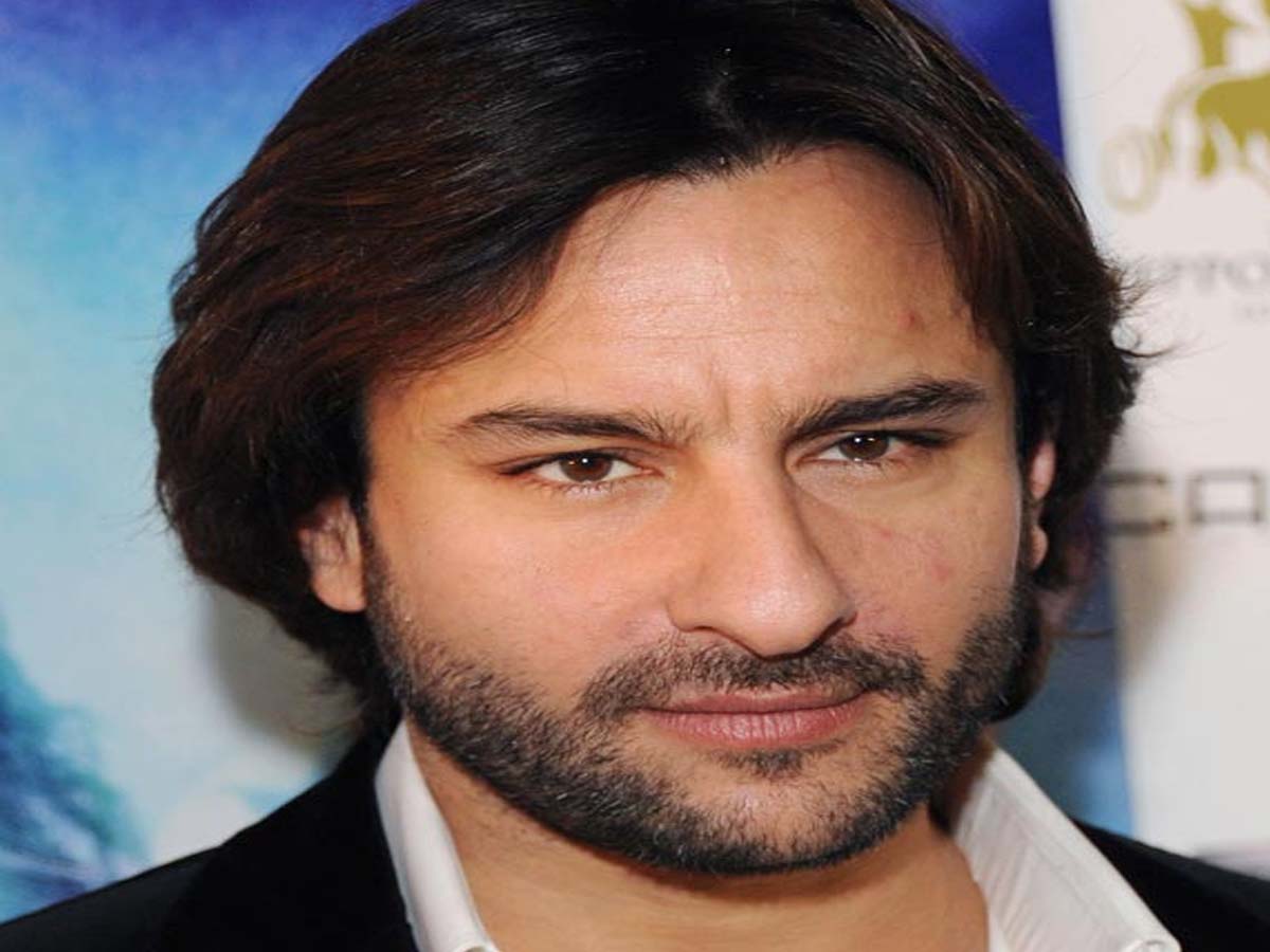 Saif Ali Khan in coat with white shirt posing for camera - Bollywood actors' hairstyle
