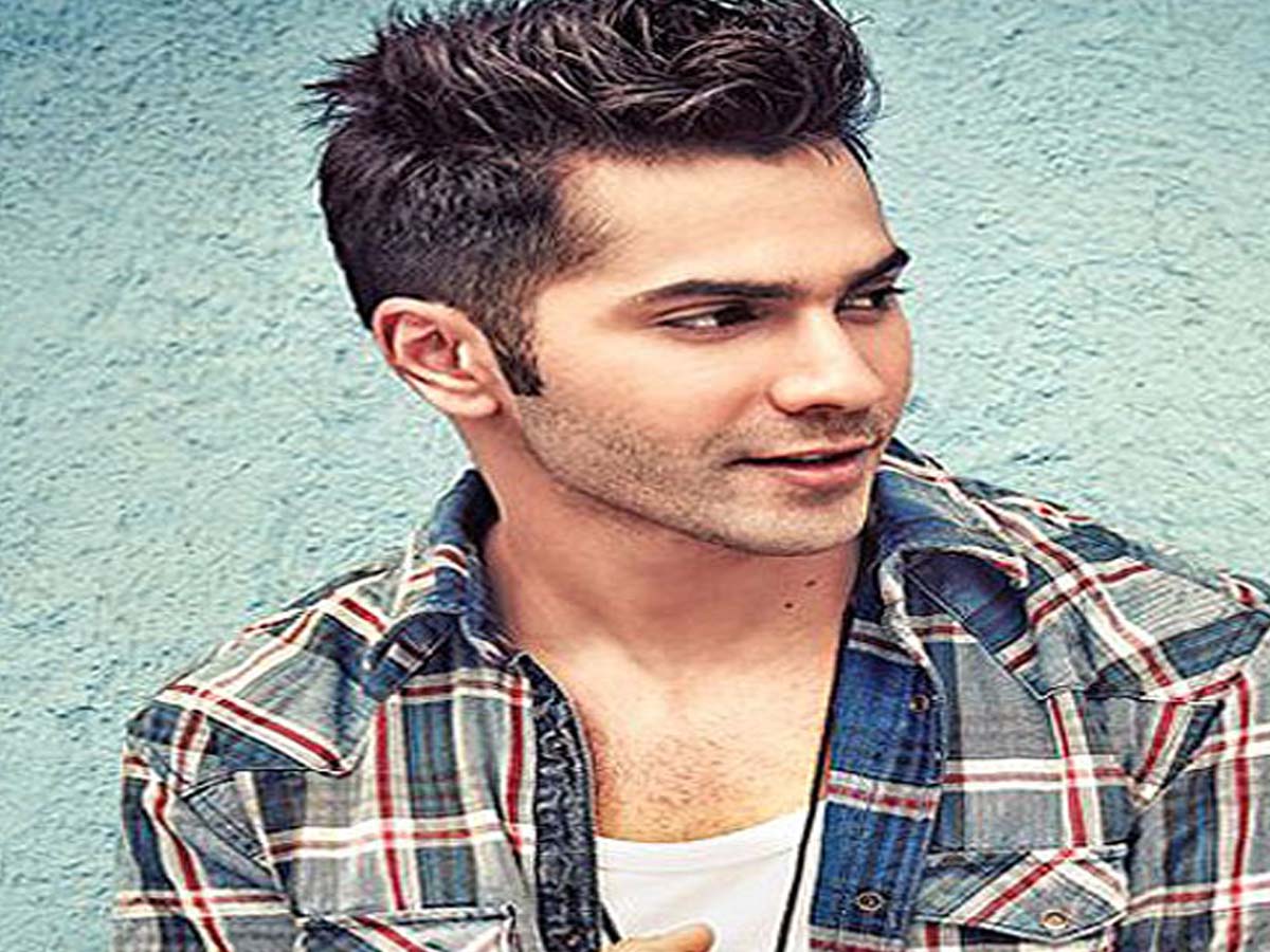 Varun Dhawan in multicolored checkered shirt posing for the camera - Bollywood actors hairstyle