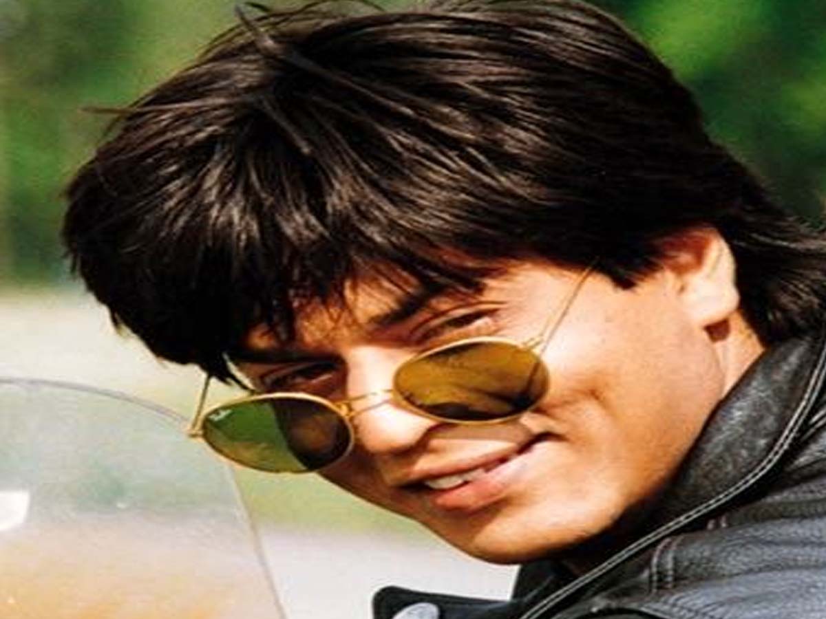 Shahrukh Khan in black leather jacket with goggles posing for camera - bollywood actors hairstyles