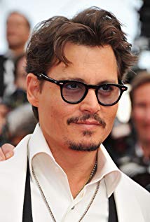 Johnny Depp in white shirt and goggles posing for camera - Johnny Depp Hairstyles