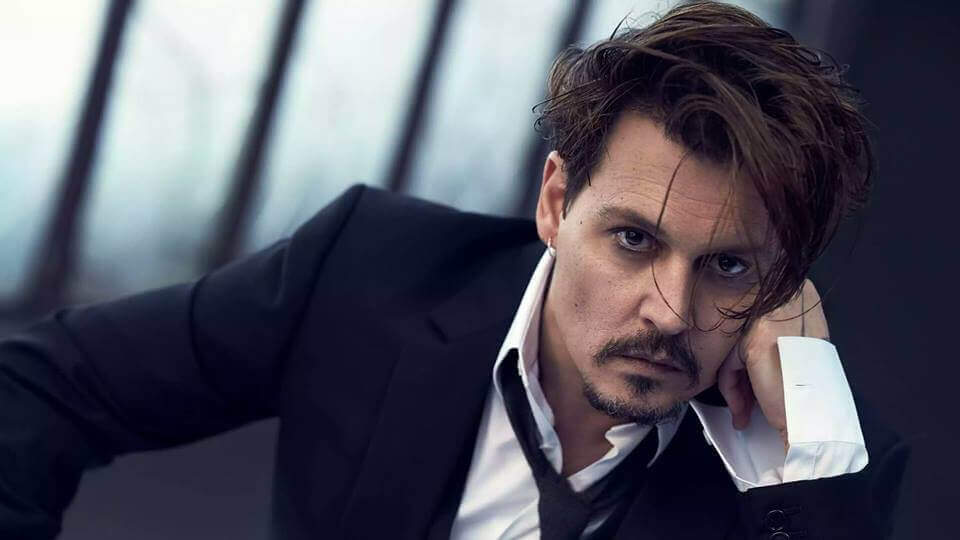 Johnny Depp in blue suit with white shirt posing for camera - Johnny Depp hairstyle 