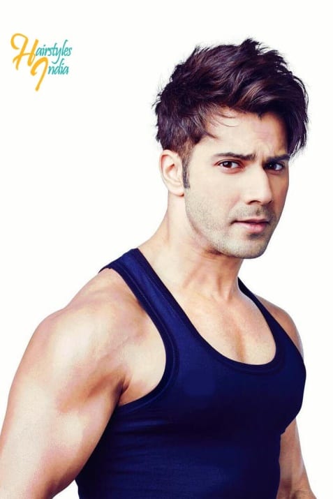 Varun Dhawan in blue vest posing for camera and showing his Combover with highlights - medium length hairstyle