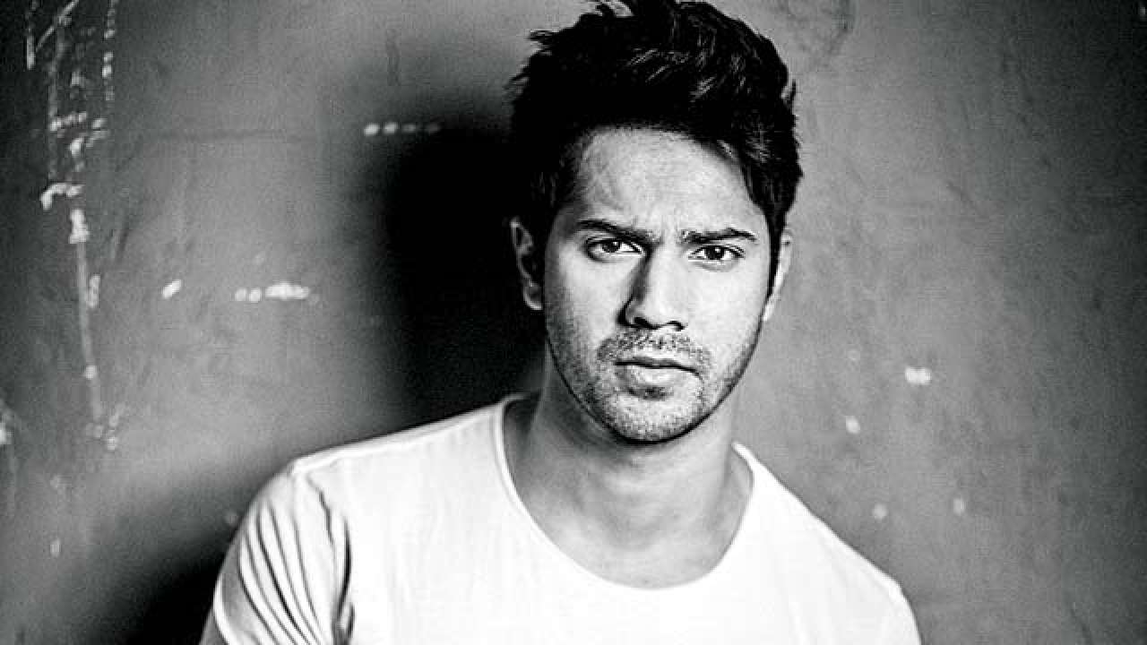Varun Dhawan posing for camera and showing his Heavy hairs with sharp spikes- Varun Dhawan Hairstyles
