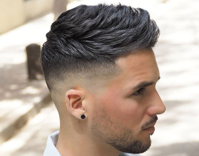 A man in white shirt showing the side view of his high tape Fade Haircut - short haircut 