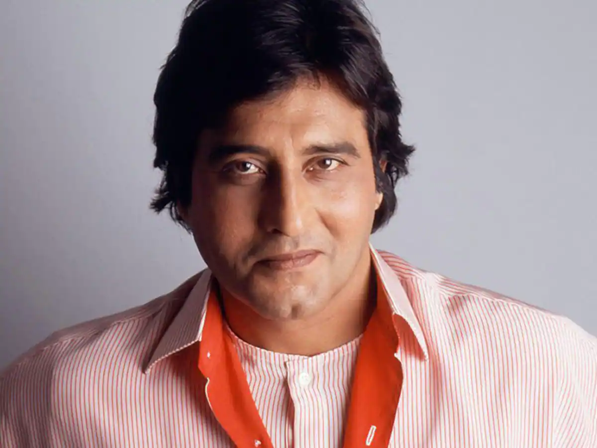 Vinod Khanna in white and Orange lining shirt posing for camera Vinod Khanna in white and Orange lining shirt posing for camera - top 10 handsome actors in Bollywood