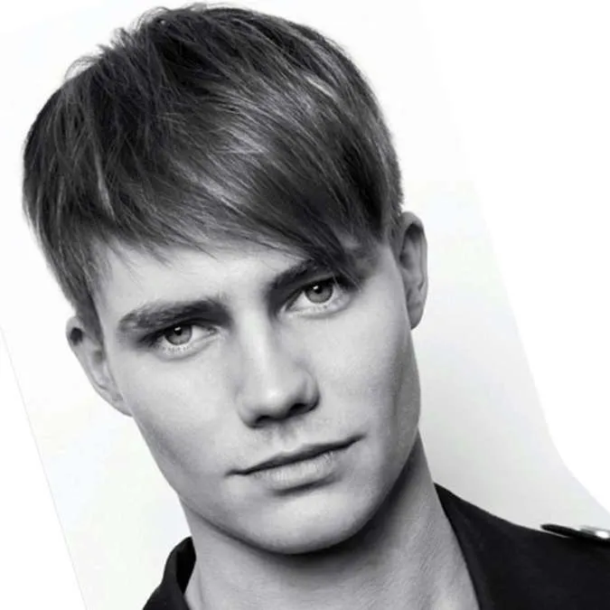 A man in black shirt showing his Angular Fringe Hairstyle A man in black shirt showing his Angular Fringe Hairstyle - latest hairstyles for Men 2022