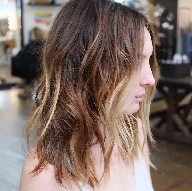 Woman in light green tank top showing the side view of her Choppy Balayage hairstyle Woman in light green tank top showing the side view of her Choppy Balayage hairstyle - Long Hairstyles