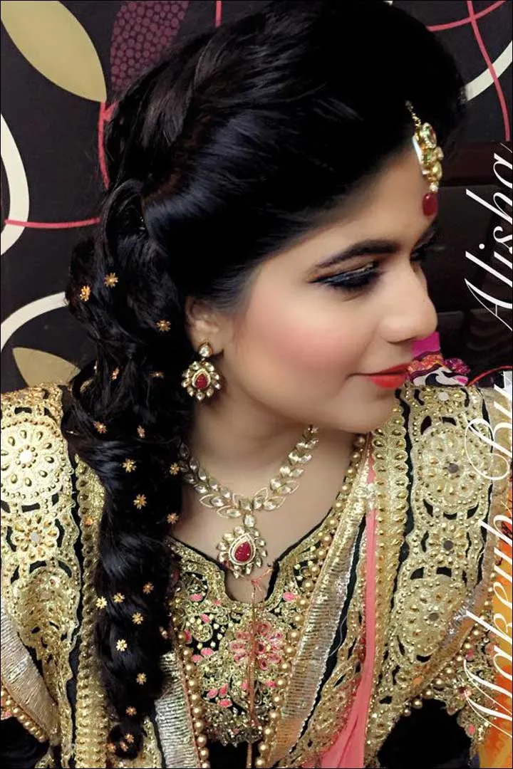 A girl in black and pink heavy emroided lehenga showing the side view of her Curl Fishtail A girl in black and pink heavy emroided lehenga showing the side view of her Curl Fishtail - ponytail hairstyles for women