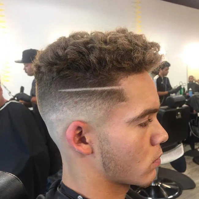 A boy is showing his Fading Curls A boy is showing his Fading Curls - Hairstyles for Boys 2021