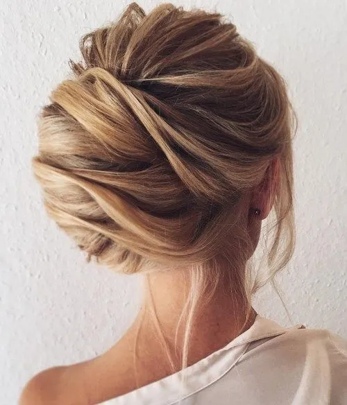 A girl in white shirt showing the back view of her French Twist Bun A girl in white shirt showing the back view of her French Twist Bun - bun hairstyles
