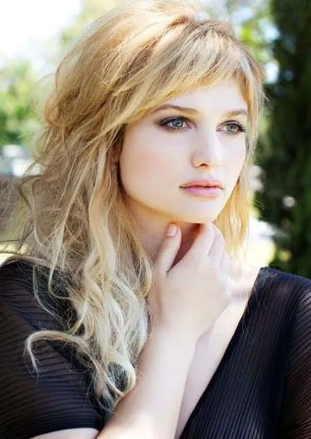 Woman in black dress with Layered Bedhead hairstyle Woman in black dress with Layered Bedhead hairstyle - hair cut for girls
