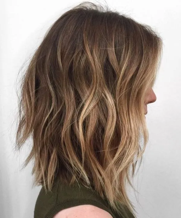 A woman in cut sleeves top showing the side view of her Light Bob hairstyles A woman in cut sleeves top showing the side view of her Light Bob hairstyles -haircuts for girls with medium hair