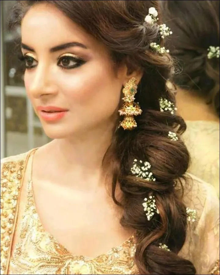 A girl in cream color traditional outfit showing the side view of her Loose Braid A girl in cream color traditional outfit showing the side view of her Loose Braid - braid hairstyles