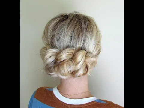 A girl in multicolor t-shirt showing the back view of her Pull through braid A girl in multicolor t-shirt showing the back view of her Pull through braid - bun hairstyles