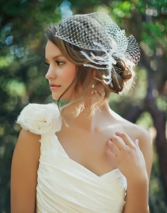 A girl in one shoulder white gown posing for camera and showing her Traditional With Veil A girl in one shoulder white gown posing for camera and showing her Traditional With Veil - Wedding hairstyles