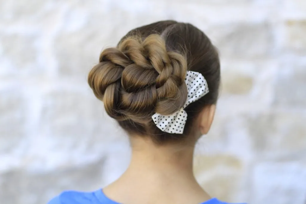 Woman in blue top with Twisted Bun Woman in blue top with Twisted Bun - hair cutting style for female with name