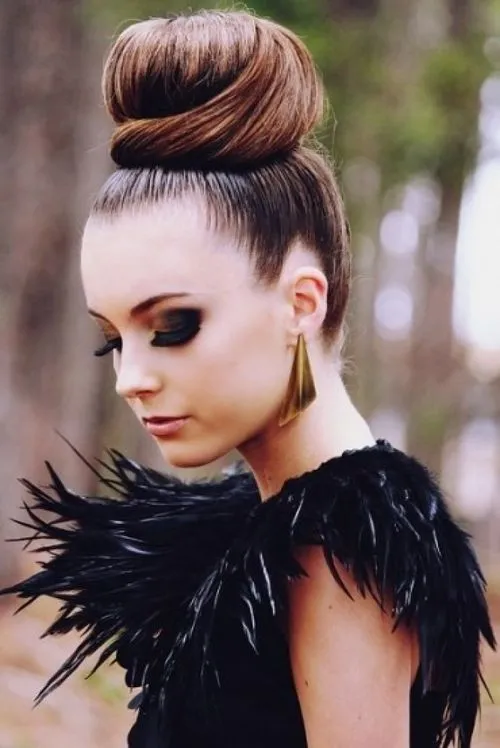 Woman in black furry dress with golden earrings and Top Bun hairstyle Woman in black furry dress with golden earrings and Top Bun hairstyle - best hairstyle for girl with long hair