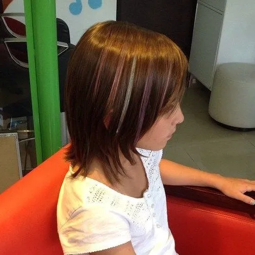 A girl in white round neck top showing the side view of her Layered bob with highlights A girl in white round neck top showing the side view of her Layered bob with highlights - Teenage Girls hairstyles