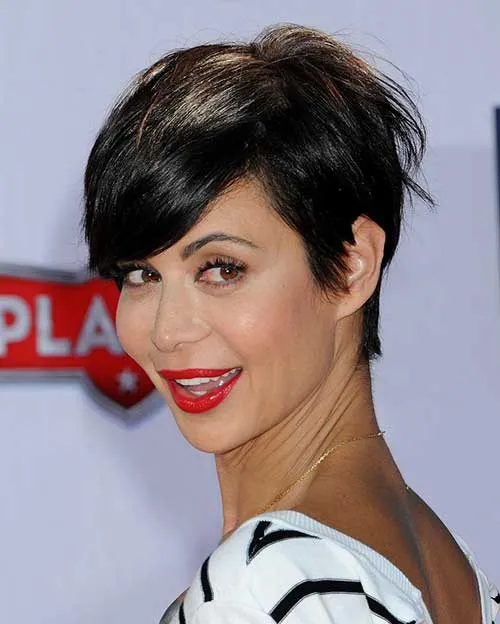 A girl in black and white lining top with red lipstick showing the side view of her Tight Brunette Pixie A girl in black and white lining top with red lipstick showing the side view of her Tight Brunette Pixie - Girls haircut