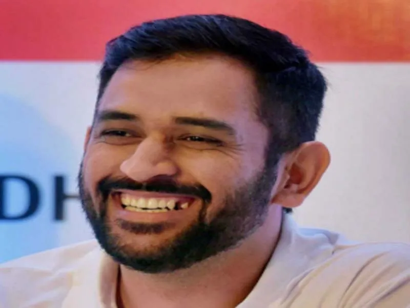 Smiling MS Dhoni in white t-shirt - MS Dhoni hairstyles