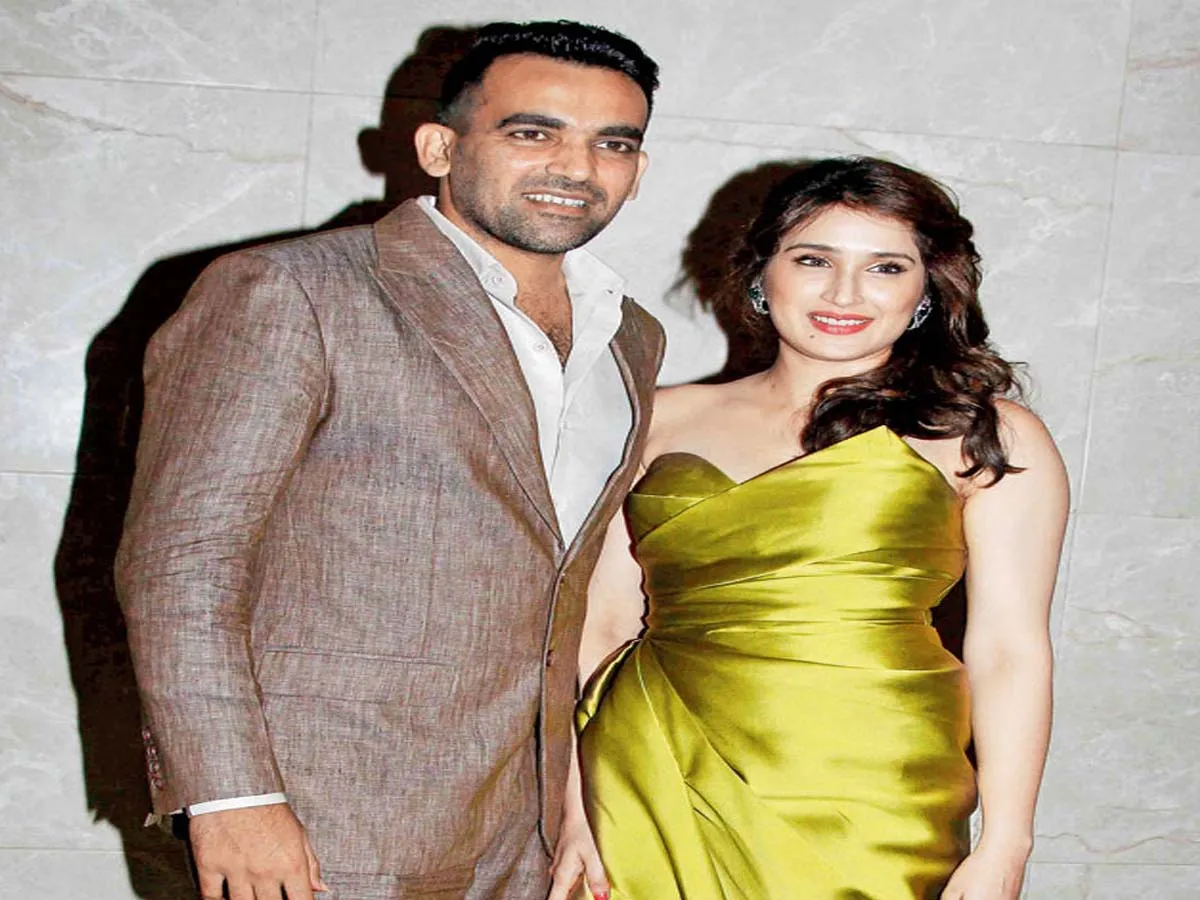 Zahir Khan and Sagarika Ghatge smiling and posing for camera Zahir Khan and Sagarika Ghatge smiling and posing for camera - indian cricketers wife