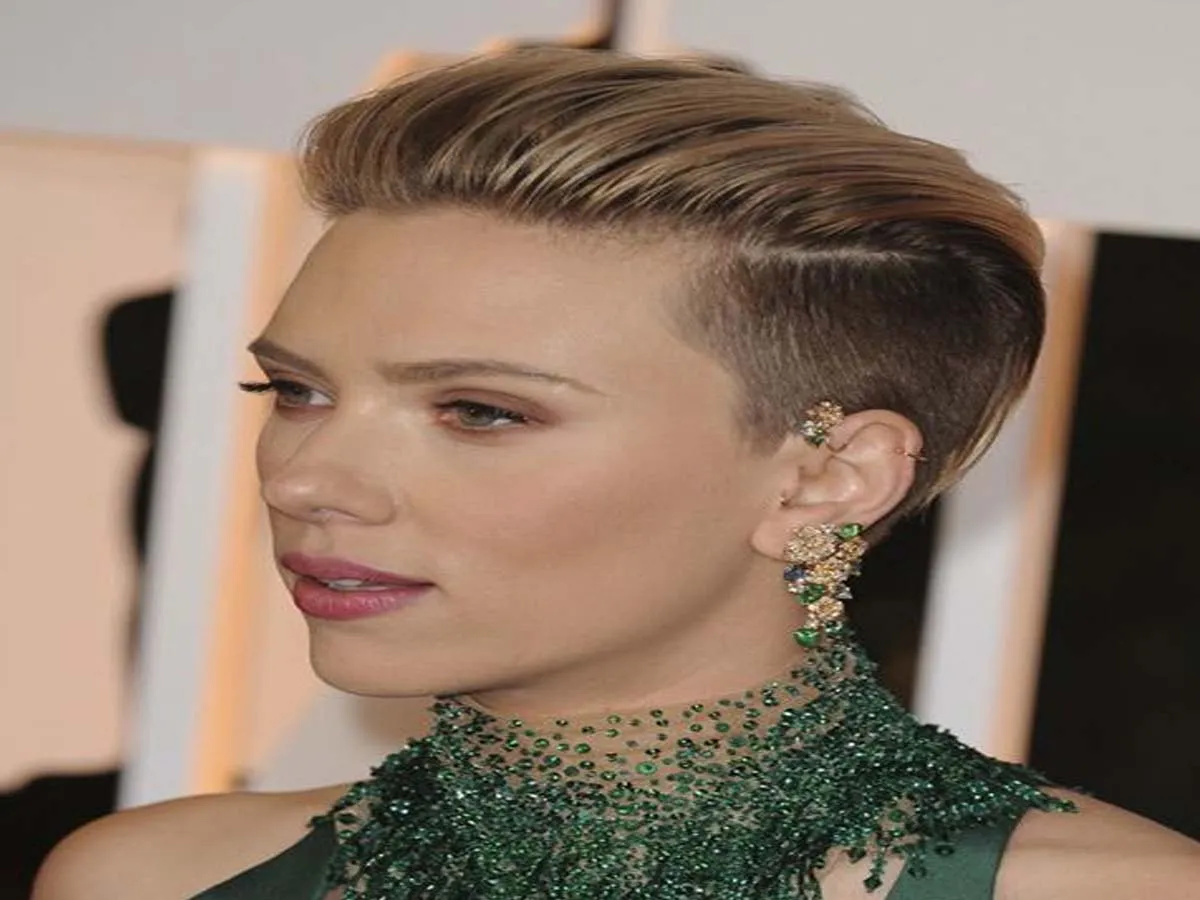 Scarlett Johansson in green net dress with matching earrings posing for camera - celebrity short hair cuts
