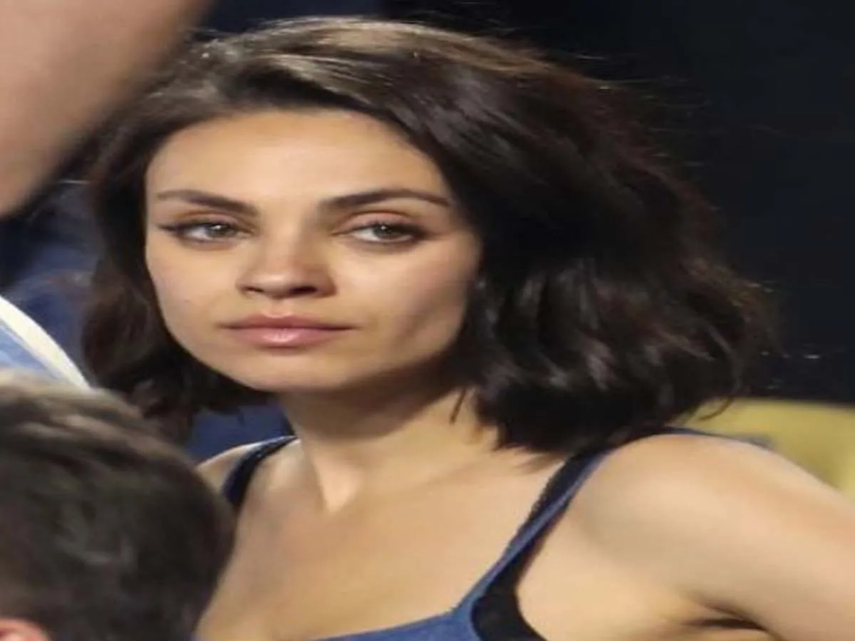 Mila Kunis in blue tank top posing for camera - hollyywood actresses with curly hair