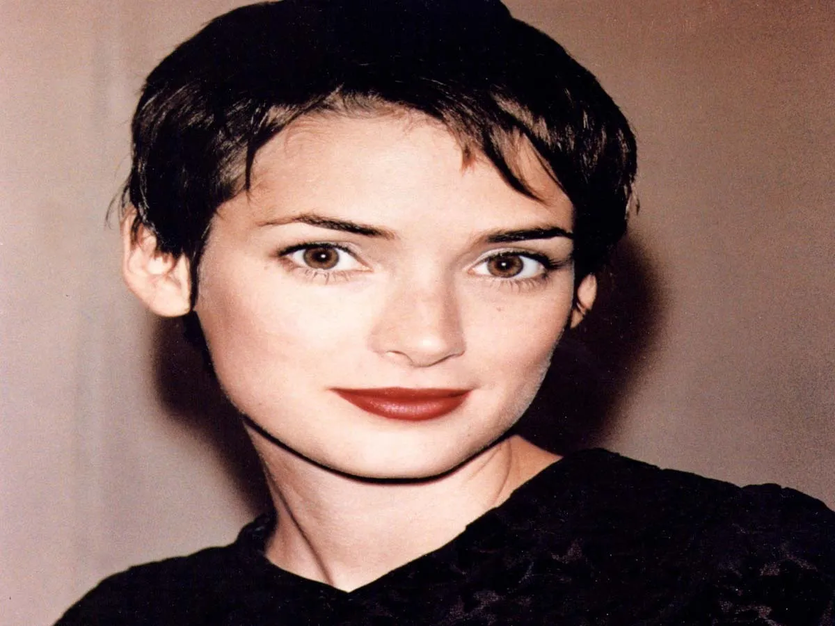 Winona Ryder in black dress with red lipstick posing for camera - hollywood actresses short hair